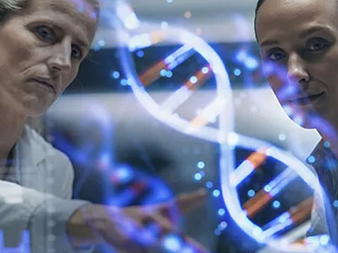 Two women in lab coats examine a DNA strand, showcasing collaboration in scientific research
